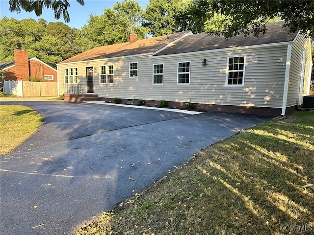 view of front facade featuring crawl space, roof with shingles, and central AC