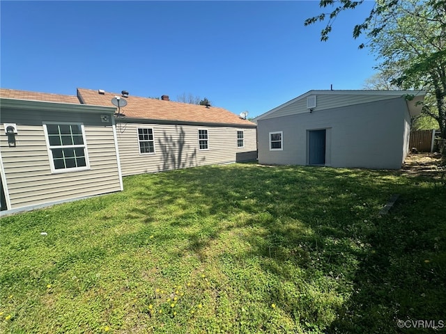 back of property featuring a yard
