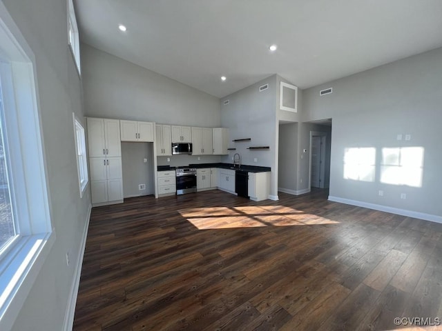 13335 Happy Hill Rd, Chesterfield, VA 23831 - kitchen featuring stainless steel appliances, high vaulted ceiling, dark countertops, a sink, and dark wood finished floors