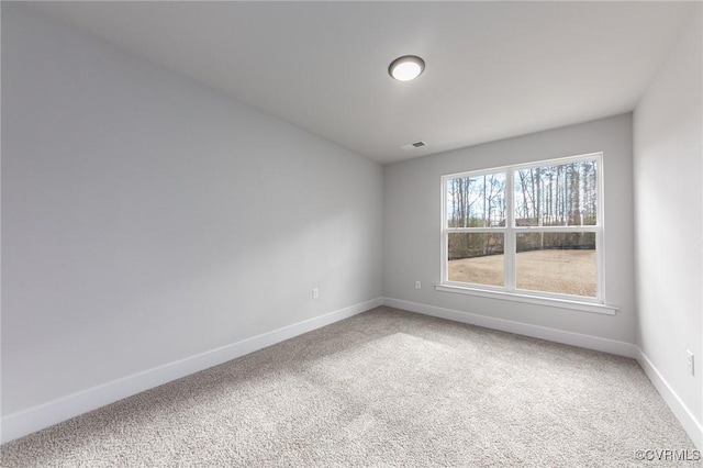carpeted spare room with baseboards