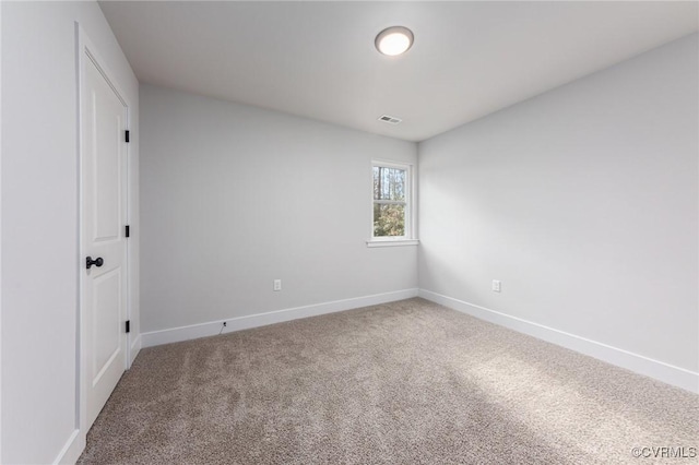 carpeted empty room with baseboards