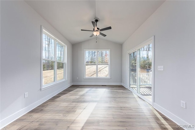 unfurnished room featuring vaulted ceiling, baseboards, a ceiling fan, and wood finished floors