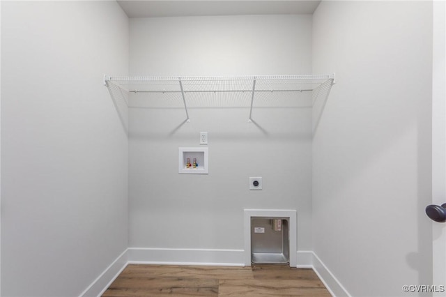 washroom featuring hookup for a washing machine, electric dryer hookup, wood finished floors, and baseboards