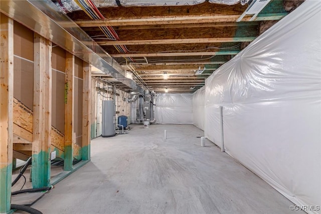 unfinished basement featuring water heater