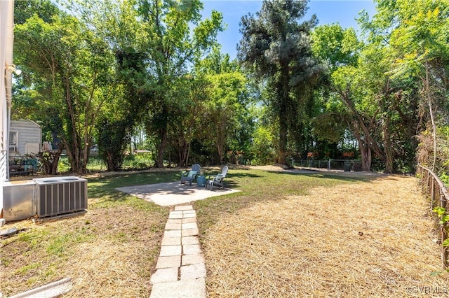 view of yard featuring cooling unit and a patio
