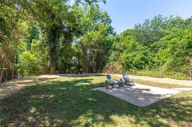 view of yard featuring a patio and a wooded view