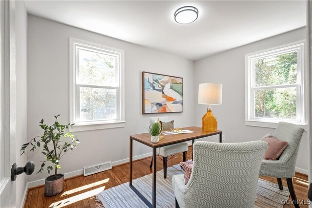office space featuring baseboards and wood finished floors