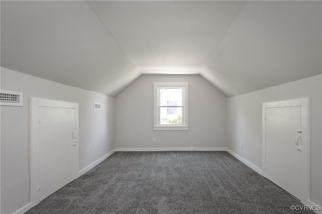 bonus room with vaulted ceiling, carpet flooring, and baseboards
