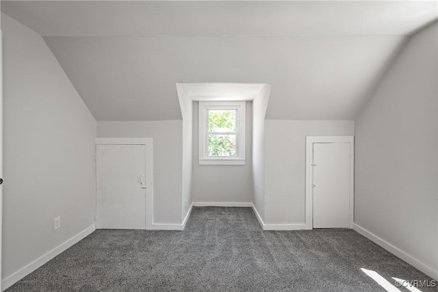 bonus room featuring lofted ceiling, carpet, and baseboards