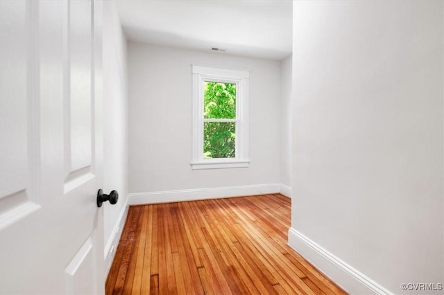 unfurnished room featuring light wood-style flooring and baseboards