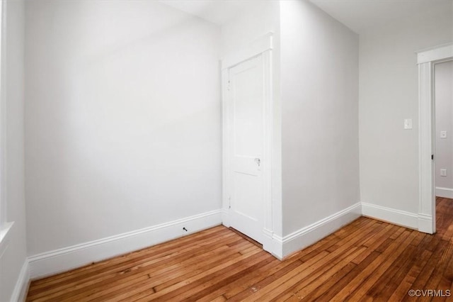 unfurnished room with light wood-style flooring and baseboards