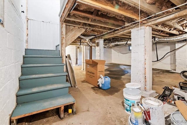 unfinished basement featuring stairway