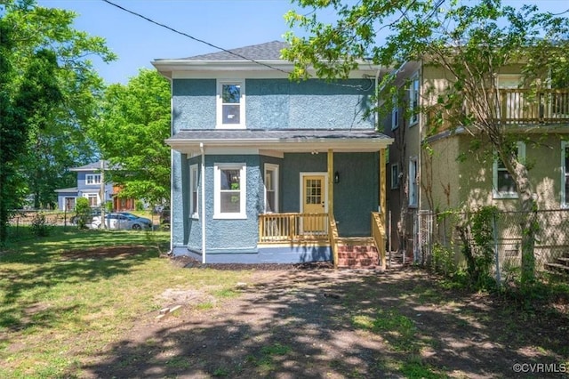 american foursquare style home with a porch and stucco siding