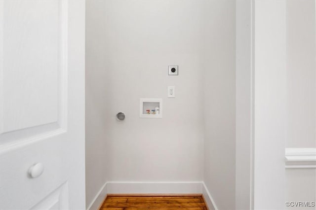 clothes washing area with electric dryer hookup, hookup for a washing machine, baseboards, and wood finished floors