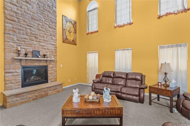 1601 Carty Bay Dr, Chester, VA 23836 - carpeted living area with a towering ceiling, plenty of natural light, a stone fireplace, and baseboards