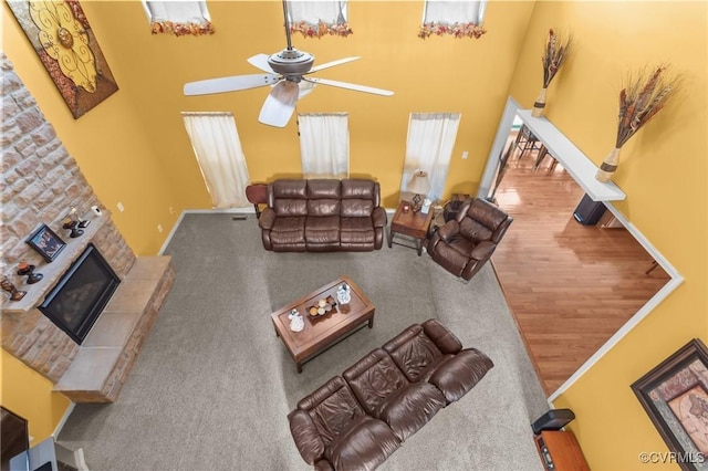 1601 Carty Bay Dr, Chester, VA 23836 - living room featuring a ceiling fan, a towering ceiling, a fireplace, and wood finished floors