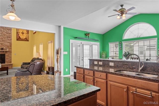 1601 Carty Bay Dr, Chester, VA 23836 - kitchen with a sink, vaulted ceiling, a ceiling fan, brown cabinets, and hanging light fixtures