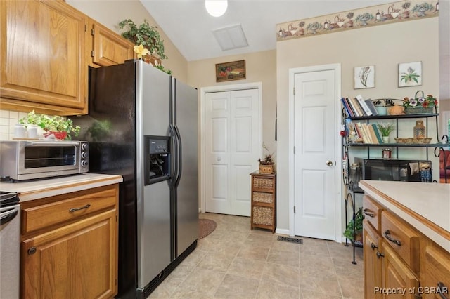 591 Plantation Rd, North, VA 23128 - kitchen with light countertops, tasteful backsplash, light tile patterned floors, and brown cabinets