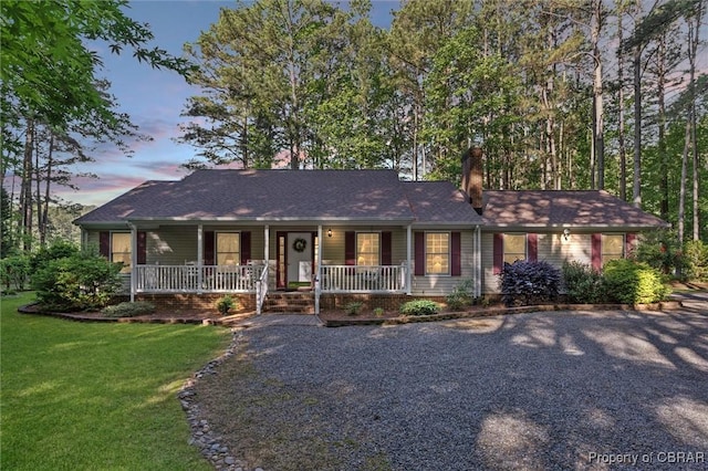 591 Plantation Rd, North, VA 23128 - ranch-style house with a porch, a chimney, a front yard, and driveway
