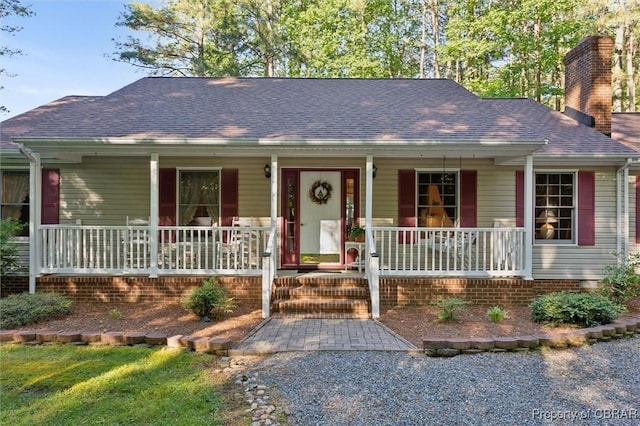 591 Plantation Rd, North, VA 23128 - ranch-style house with a porch, a chimney, and a shingled roof