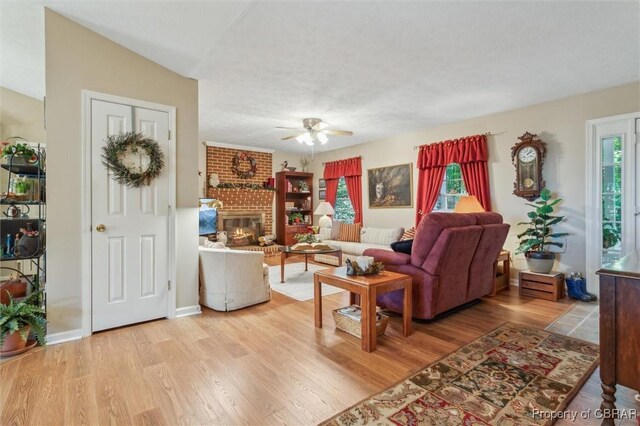 591 Plantation Rd, North, VA 23128 - living room with a ceiling fan, light wood finished floors, and a fireplace