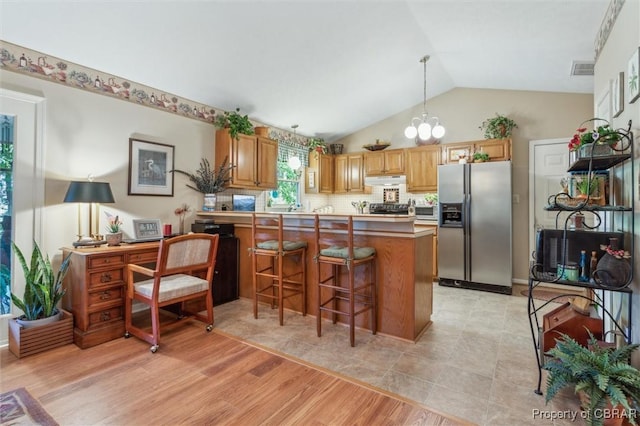 591 Plantation Rd, North, VA 23128 - kitchen featuring stainless steel refrigerator with ice dispenser, vaulted ceiling, a peninsula, under cabinet range hood, and a chandelier