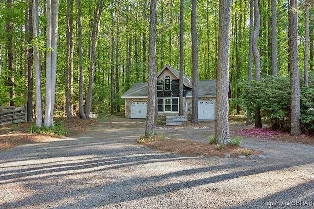 591 Plantation Rd, North, VA 23128 - view of front facade with an attached garage, driveway, and a view of trees