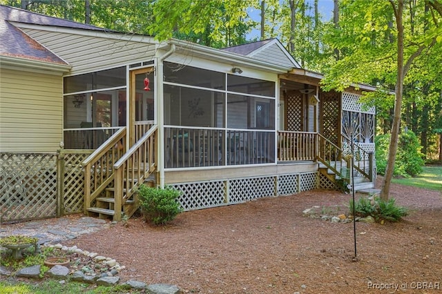 591 Plantation Rd, North, VA 23128 - view of front facade featuring a shingled roof, a sunroom, and stairway