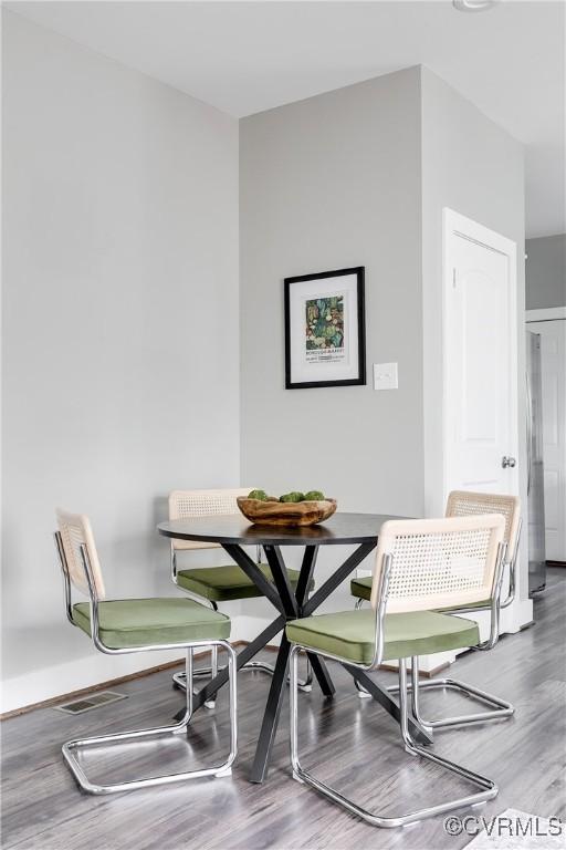 dining space with wood finished floors