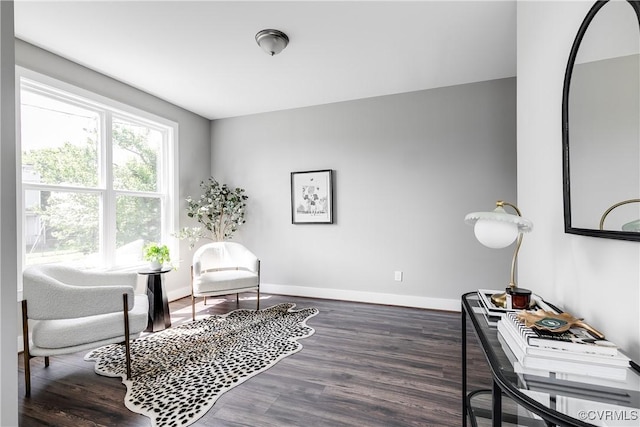 sitting room with baseboards and wood finished floors