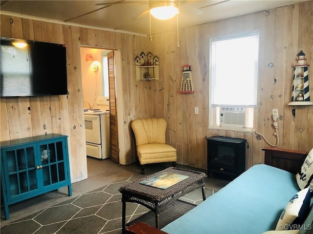 41 Hobday St, Mathews, VA 23128 - living area featuring wooden walls, cooling unit, ceiling fan, and carpet