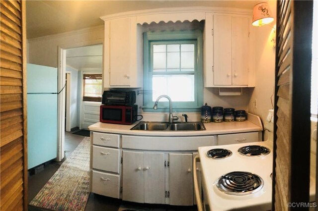 41 Hobday St, Mathews, VA 23128 - kitchen featuring white appliances, light countertops, crown molding, and white cabinets