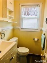 41 Hobday St, Mathews, VA 23128 - half bathroom with a wainscoted wall, healthy amount of natural light, and vanity