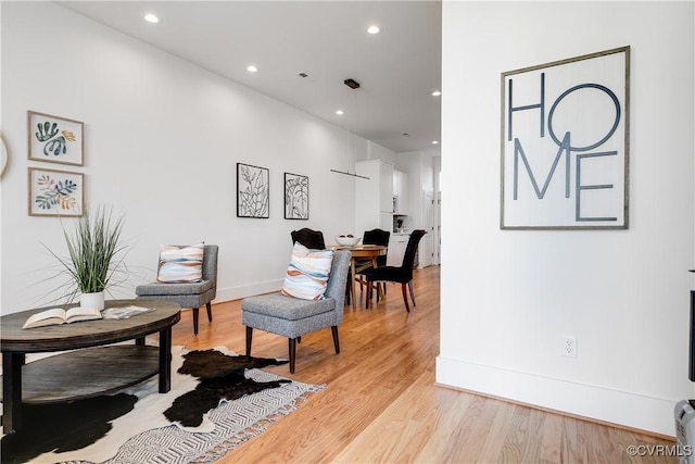 sitting room featuring light wood-style floors, recessed lighting, and baseboards