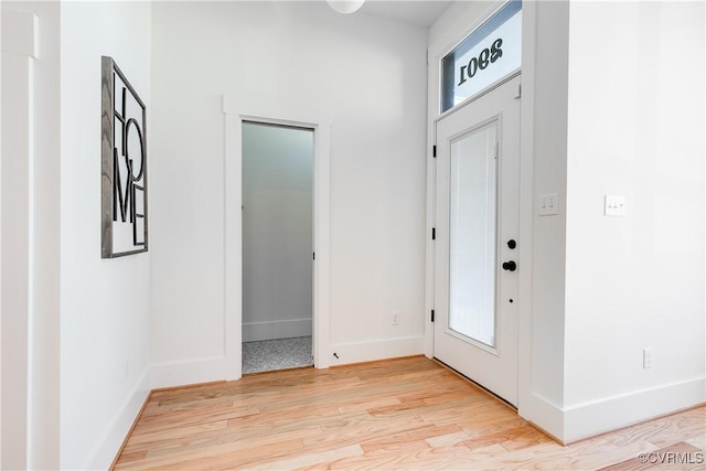 entrance foyer featuring light wood finished floors and baseboards