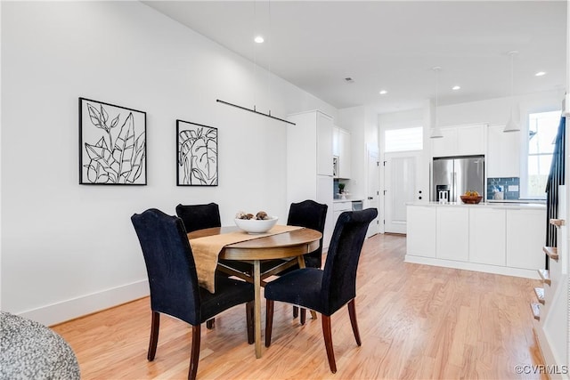 dining area featuring light wood-style floors, recessed lighting, and baseboards