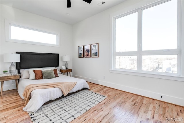 bedroom featuring wood finished floors, baseboards, and ceiling fan