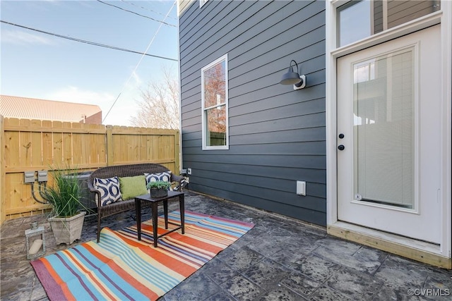 view of patio / terrace with an outdoor hangout area and fence