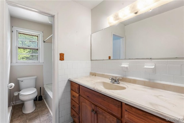 full bathroom with toilet, vanity, tile patterned floors, and  shower combination