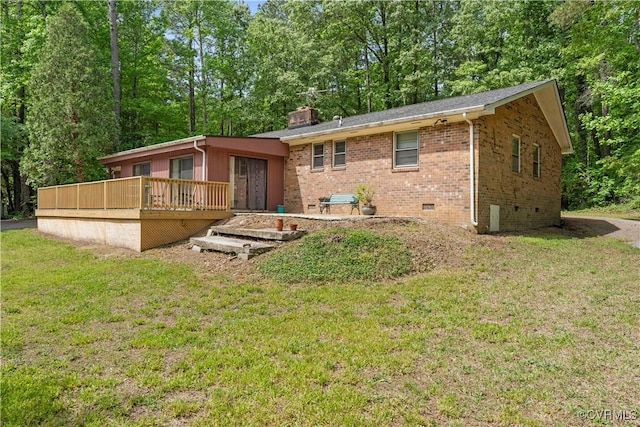 back of house with a wooden deck, brick siding, a lawn, a chimney, and crawl space