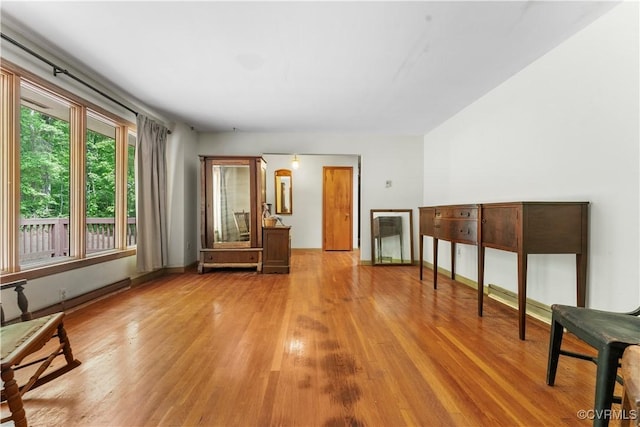 living area with wood finished floors and baseboards