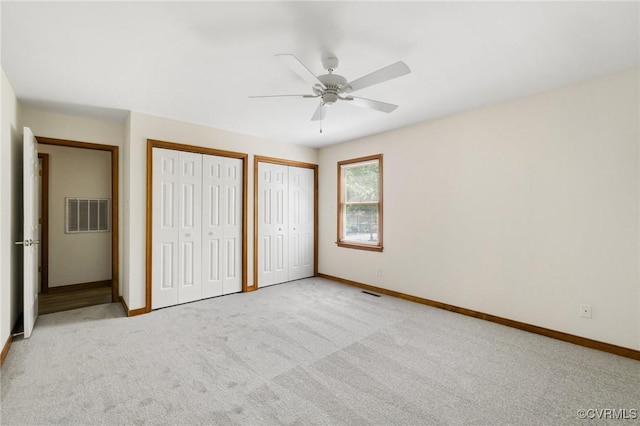 9606 Ladue Rd, North Chesterfield, VA 23237 - unfurnished bedroom featuring multiple closets, baseboards, carpet flooring, and a ceiling fan