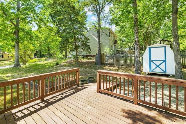 9606 Ladue Rd, North Chesterfield, VA 23237 - deck featuring a storage unit, an outdoor structure, fence, and view of scattered trees