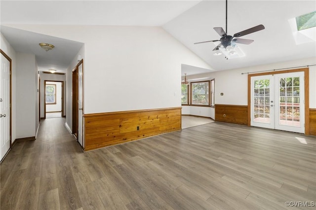 9606 Ladue Rd, North Chesterfield, VA 23237 - unfurnished living room with french doors, ceiling fan, wood finished floors, vaulted ceiling, and a skylight