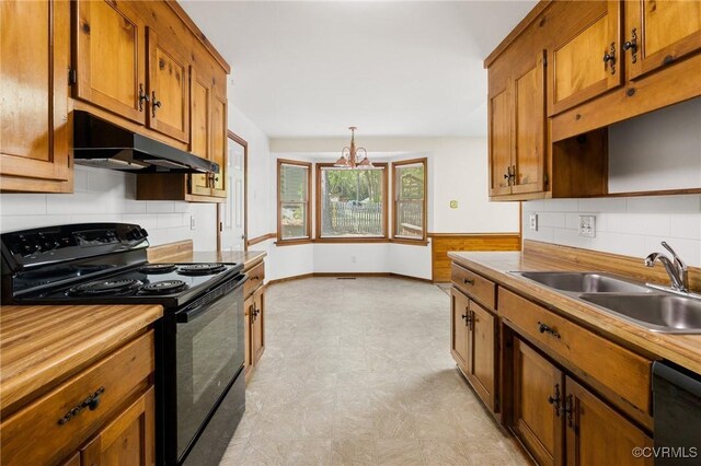 9606 Ladue Rd, North Chesterfield, VA 23237 - kitchen featuring black appliances, a sink, under cabinet range hood, light flooring, and brown cabinetry