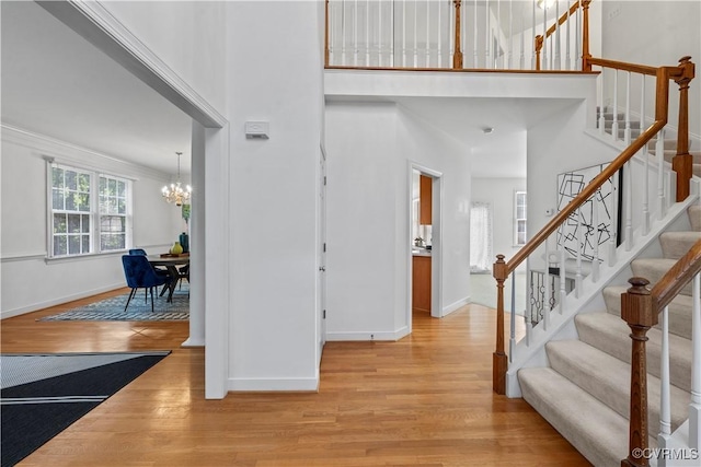 11324 Regalia Dr, Chesterfield, VA 23838 - entrance foyer with a chandelier, wood finished floors, baseboards, a towering ceiling, and stairs