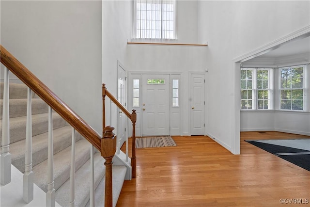 11324 Regalia Dr, Chesterfield, VA 23838 - entrance foyer with light wood-style flooring, stairway, a towering ceiling, and baseboards