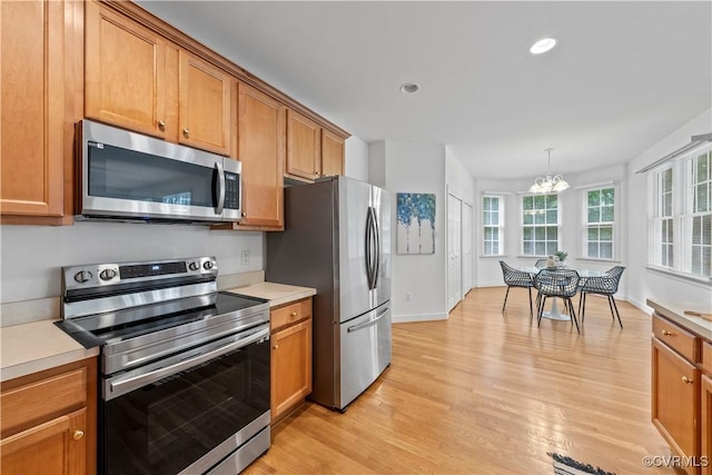11324 Regalia Dr, Chesterfield, VA 23838 - kitchen with appliances with stainless steel finishes, light wood-style flooring, brown cabinetry, light countertops, and recessed lighting