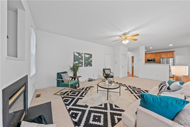 11324 Regalia Dr, Chesterfield, VA 23838 - living room with light carpet, a ceiling fan, a fireplace with flush hearth, recessed lighting, and baseboards