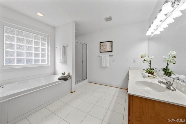11324 Regalia Dr, Chesterfield, VA 23838 - full bath with double vanity, a garden tub, a shower stall, tile patterned floors, and baseboards